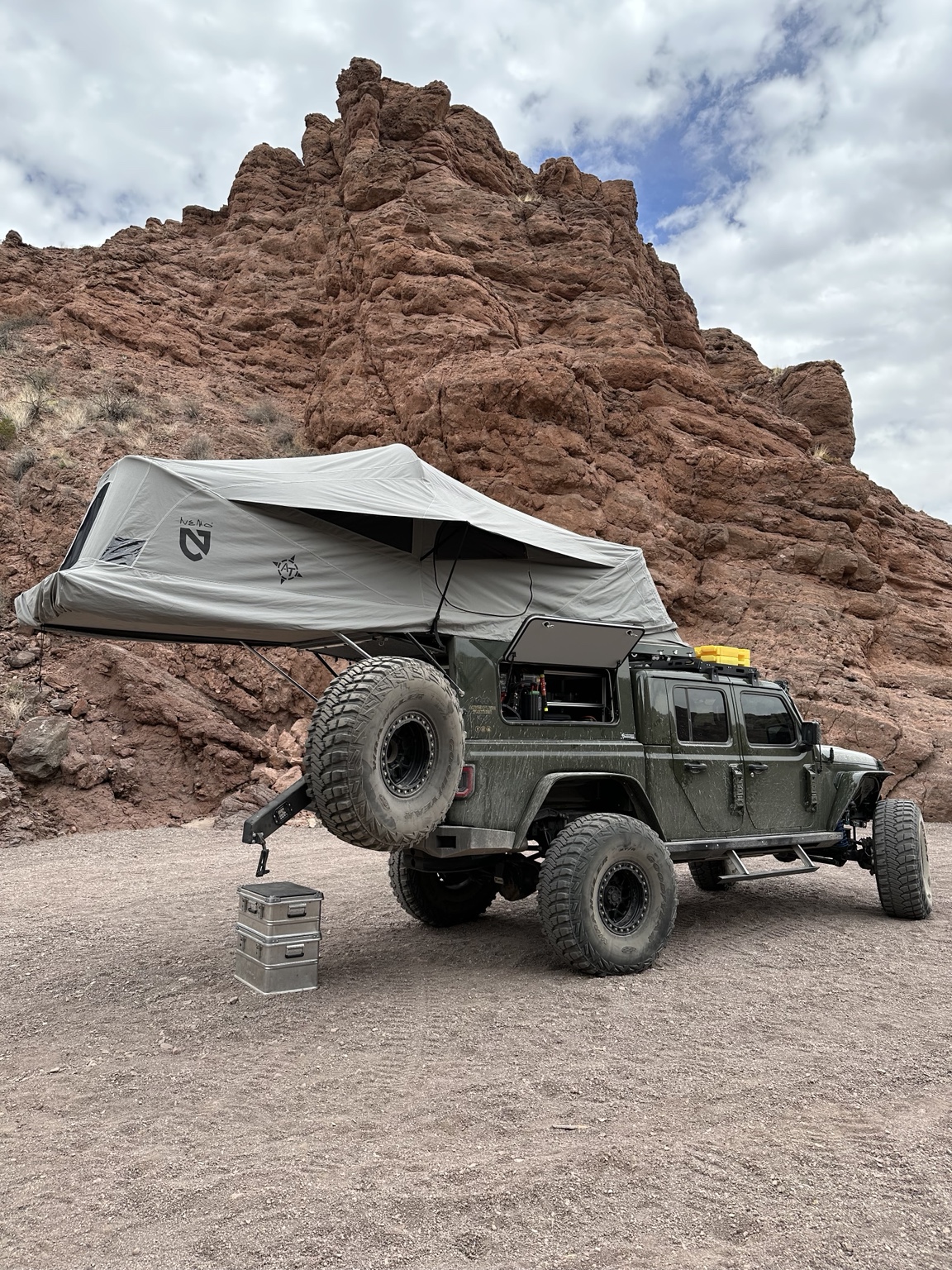 Diesel Jeep Gladiator on 42-inch tires with an open camper